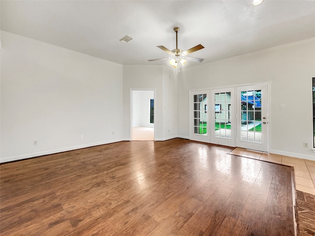 empty room featuring ceiling fan, wood-type flooring, and ornamental molding