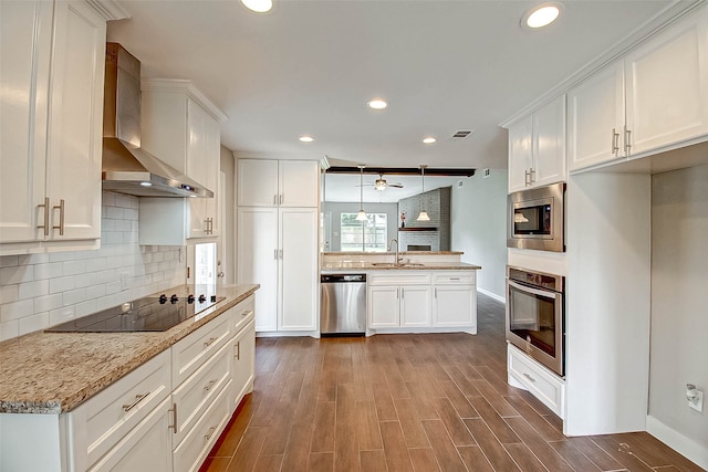 kitchen featuring white cabinetry, sink, stainless steel appliances, wall chimney range hood, and dark hardwood / wood-style floors