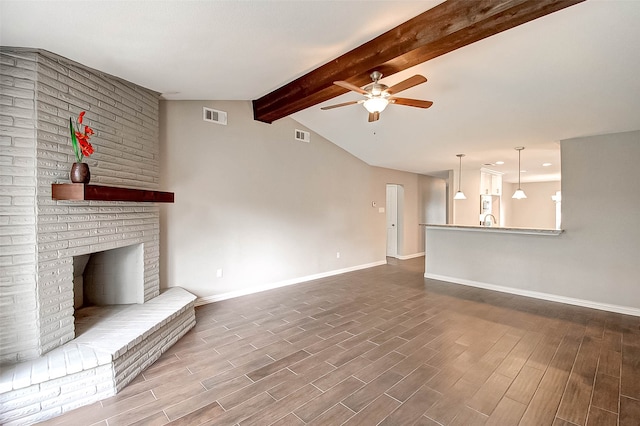 unfurnished living room with a fireplace, wood-type flooring, vaulted ceiling with beams, and ceiling fan