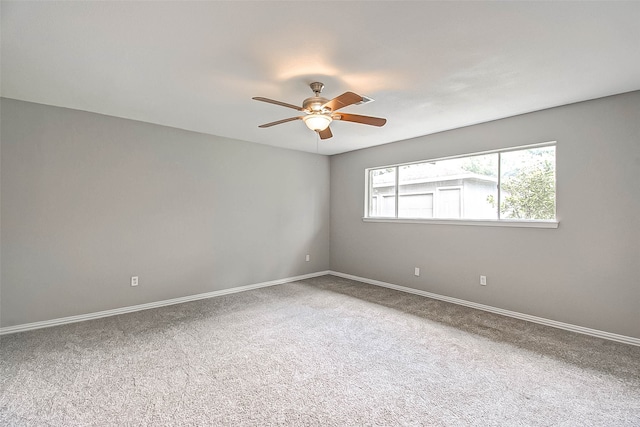 spare room featuring carpet flooring and ceiling fan