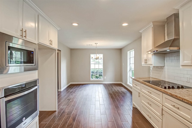 kitchen featuring dark hardwood / wood-style flooring, stainless steel appliances, white cabinetry, and wall chimney range hood