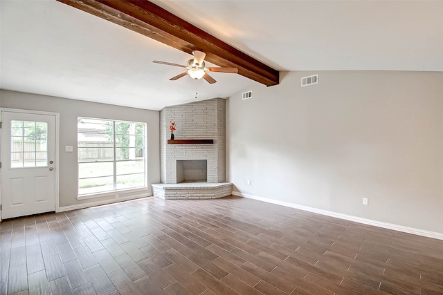 unfurnished living room featuring ceiling fan, a fireplace, lofted ceiling with beams, and dark hardwood / wood-style floors