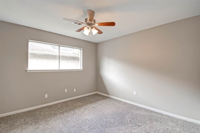 empty room featuring ceiling fan and carpet floors