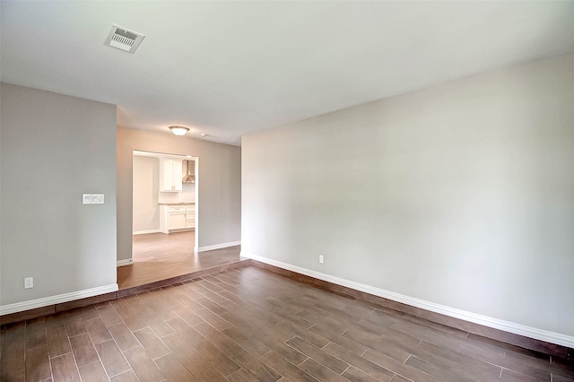 unfurnished room with wood-type flooring