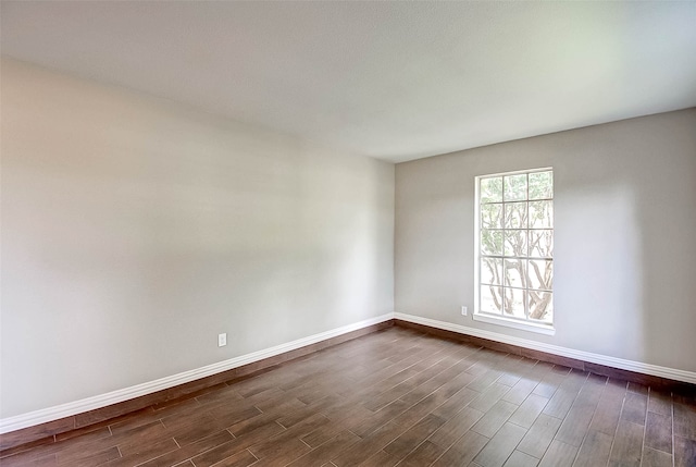 spare room featuring dark wood-type flooring