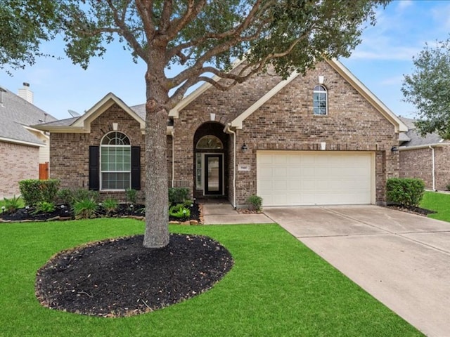 9410 Trinity Trail Ct, Cypress, TX 77433 - traditional-style house with driveway, a front yard, and brick siding