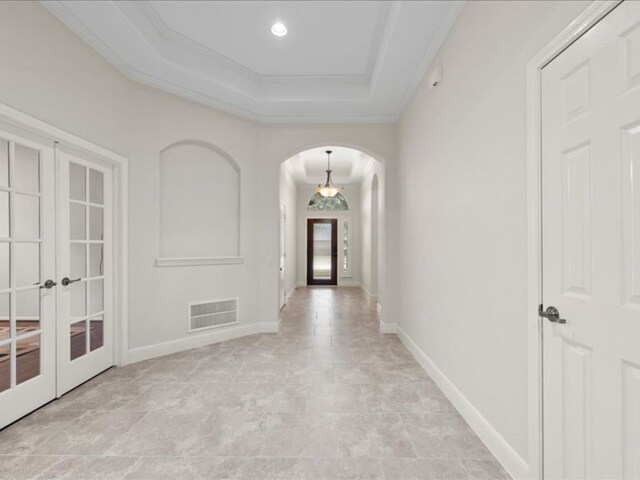 9410 Trinity Trail Ct, Cypress, TX 77433 - hall with arched walkways, french doors, a tray ceiling, ornamental molding, and baseboards