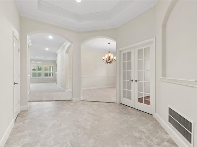 interior space with french doors, ceiling fan with notable chandelier, and crown molding