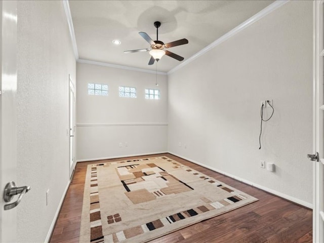 empty room featuring ornamental molding, hardwood / wood-style floors, and ceiling fan