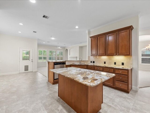 9410 Trinity Trail Ct, Cypress, TX 77433 - kitchen featuring dishwasher, a peninsula, brown cabinets, a center island, and light stone countertops