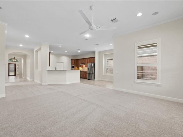 unfurnished living room with light carpet, crown molding, and ceiling fan