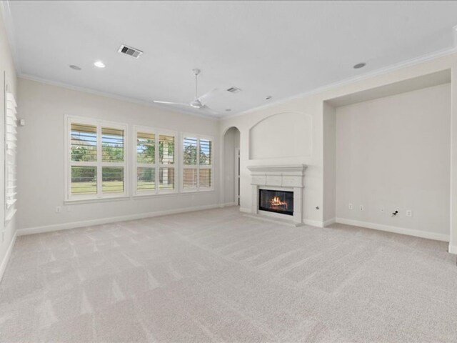9410 Trinity Trail Ct, Cypress, TX 77433 - unfurnished living room with crown molding, baseboards, a glass covered fireplace, ceiling fan, and light colored carpet