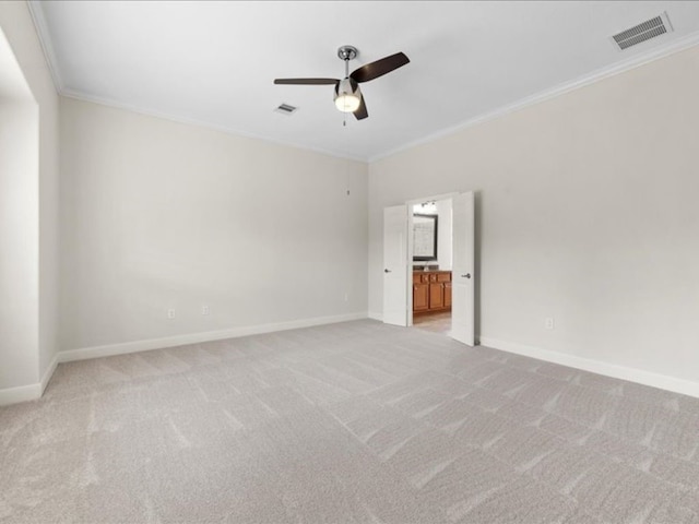 empty room featuring crown molding, light colored carpet, and ceiling fan