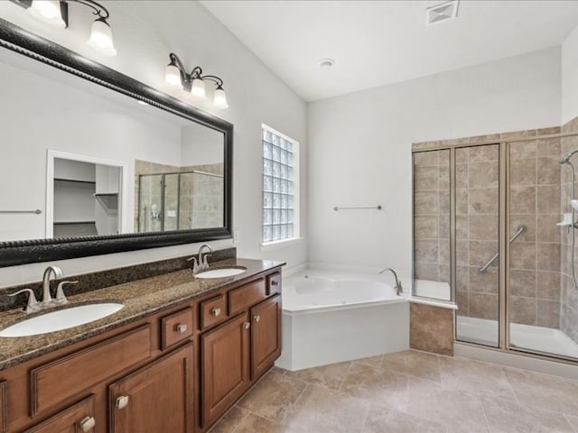 bathroom with vanity and separate shower and tub