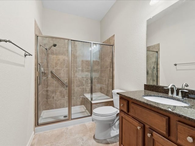 bathroom with toilet, a shower with shower door, vanity, and tile patterned flooring