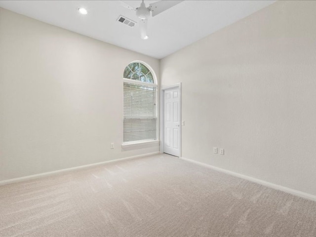 empty room featuring light carpet and ceiling fan