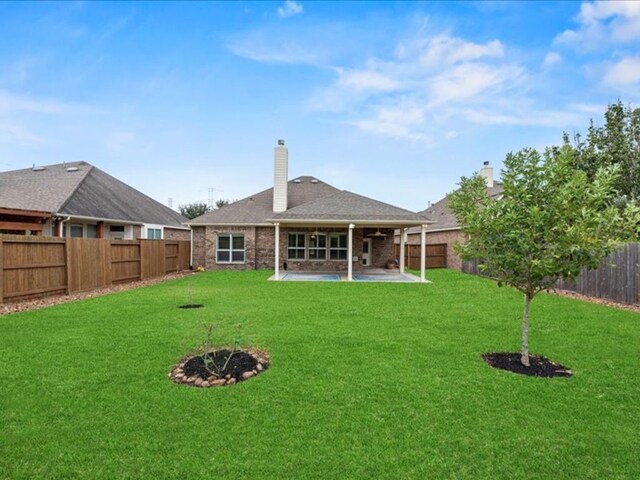 9410 Trinity Trail Ct, Cypress, TX 77433 - rear view of property featuring a patio and a chimney
