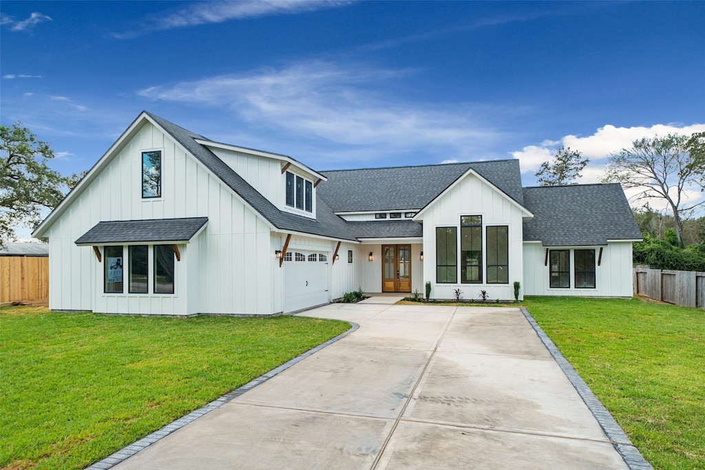 modern farmhouse style home with a garage and a front yard