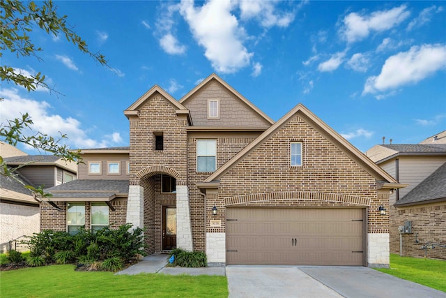 view of front of property featuring a front yard and a garage