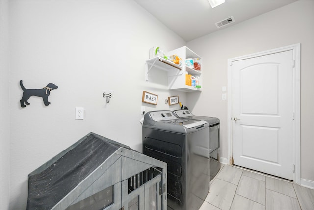 washroom with washing machine and clothes dryer