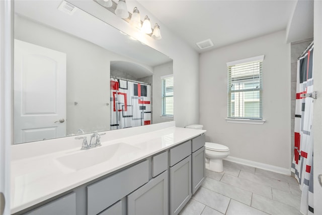 bathroom featuring toilet, vanity, and tile patterned floors