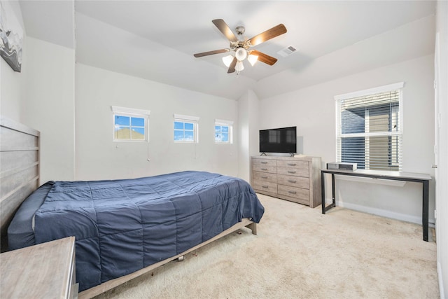 bedroom featuring ceiling fan, vaulted ceiling, and light colored carpet