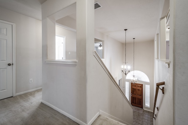 interior space with carpet and a notable chandelier