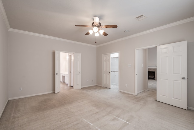 empty room featuring crown molding, light carpet, and ceiling fan