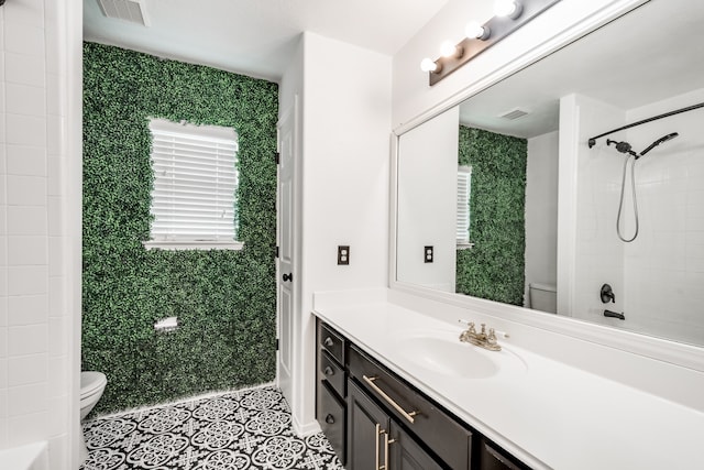 bathroom featuring vanity, toilet, and walk in shower