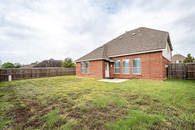 rear view of house with a patio area and a lawn