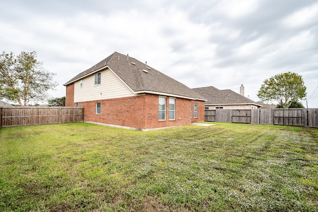 back of property featuring a yard