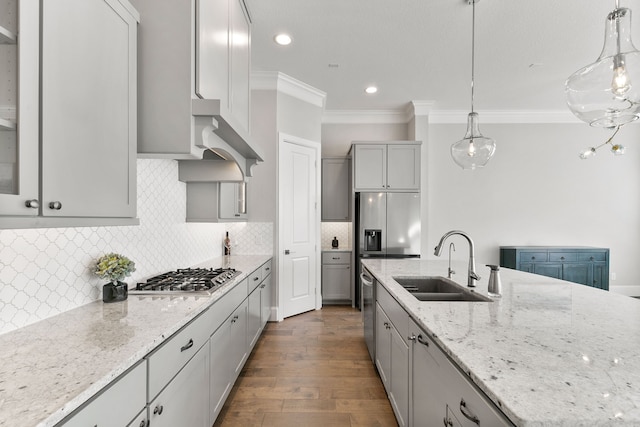 kitchen featuring hanging light fixtures, sink, appliances with stainless steel finishes, and dark wood-type flooring