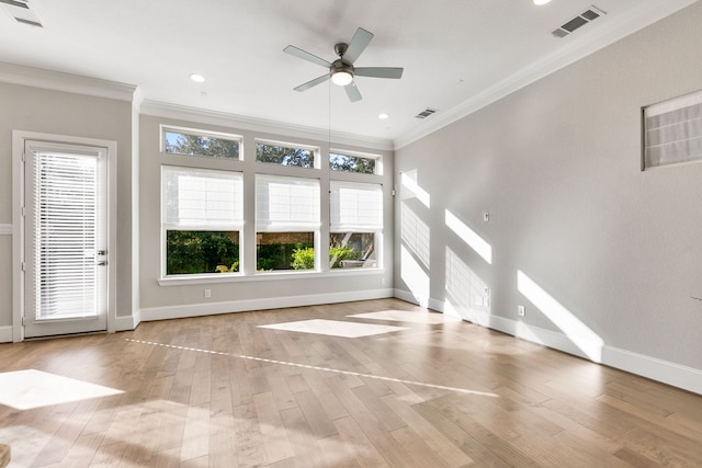 unfurnished living room with light wood-type flooring, crown molding, and a healthy amount of sunlight