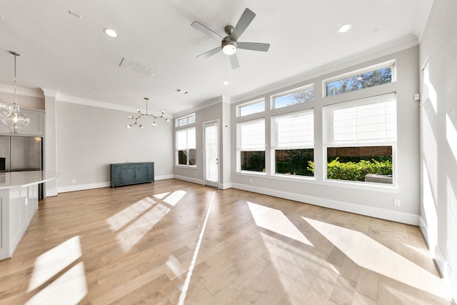 unfurnished living room featuring ceiling fan with notable chandelier, crown molding, and light hardwood / wood-style flooring