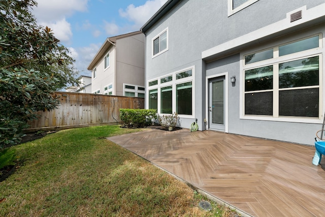 rear view of property featuring a yard