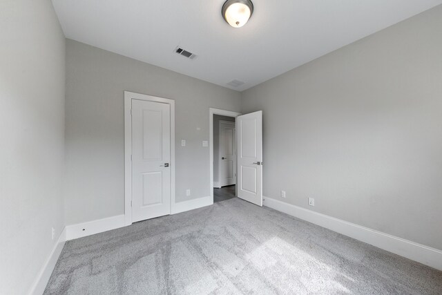 unfurnished bedroom with carpet floors and a closet