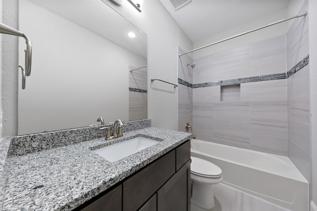 full bathroom with vanity, toilet, and tiled shower / bath combo