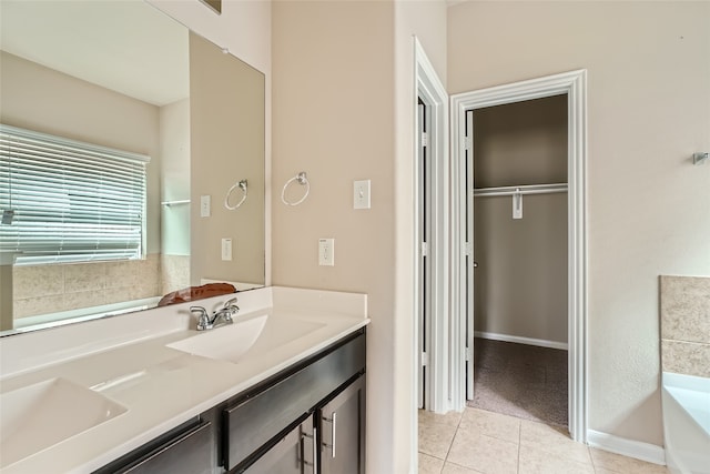 bathroom featuring vanity, a tub, and tile patterned floors