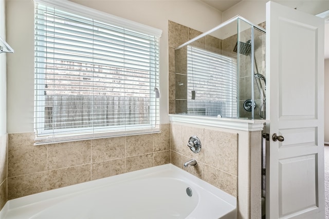 bathroom featuring a wealth of natural light and plus walk in shower