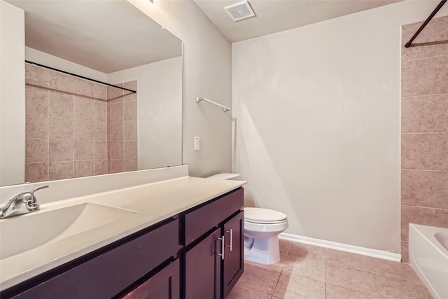 full bathroom with vanity, tiled shower / bath combo, toilet, and tile patterned flooring