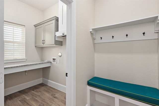 mudroom featuring built in desk and wood-type flooring