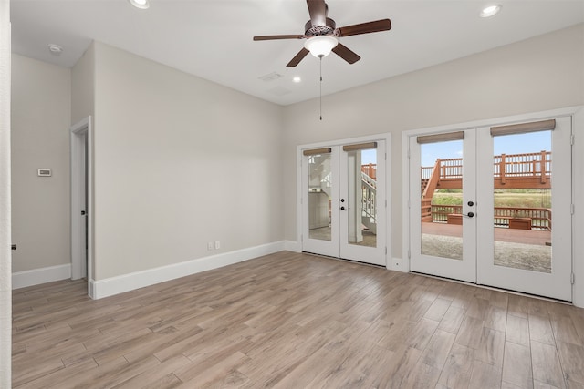 spare room featuring french doors, ceiling fan, and light hardwood / wood-style flooring