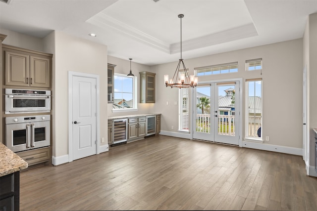 kitchen featuring wine cooler, dark hardwood / wood-style flooring, french doors, and light stone counters