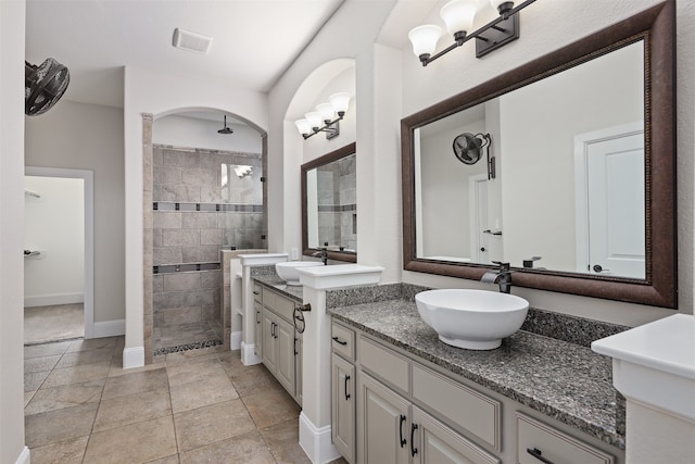 bathroom with vanity, tile patterned floors, and tiled shower