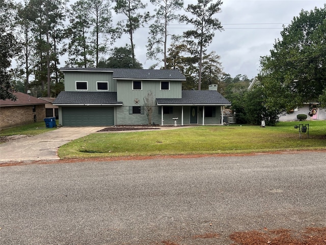 view of front of property featuring a front yard and a garage