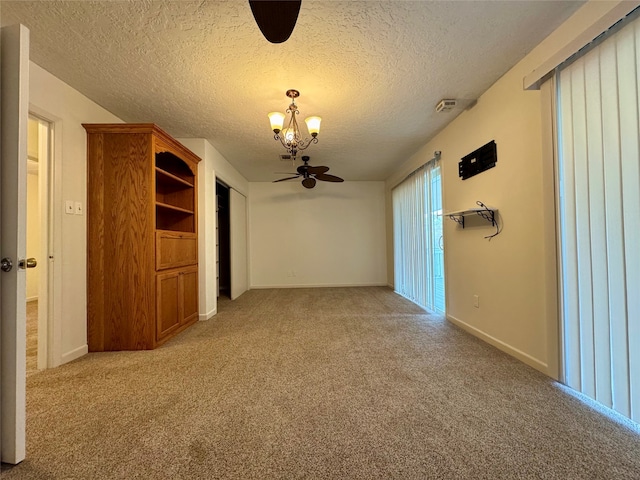 unfurnished room featuring ceiling fan, a textured ceiling, and light colored carpet