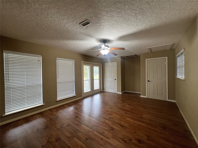 unfurnished room featuring ceiling fan, a textured ceiling, and dark hardwood / wood-style flooring