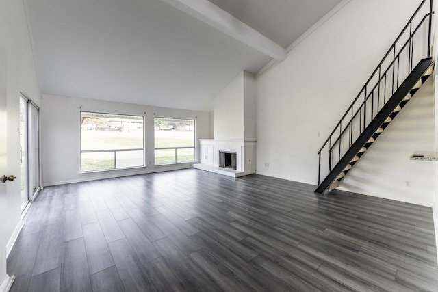 unfurnished living room featuring beamed ceiling, a brick fireplace, dark hardwood / wood-style floors, and high vaulted ceiling