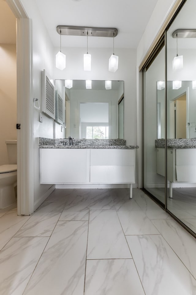 bathroom with vanity and toilet