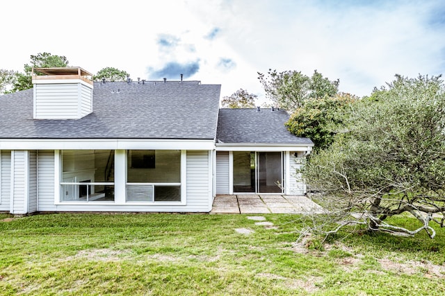 back of property with a patio and a lawn